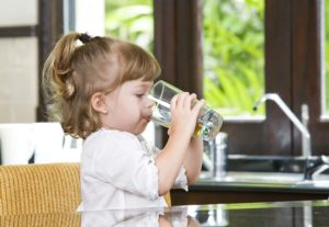 Child drinking water from glass