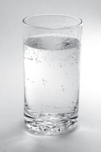 Clear, bubbly water in a transparent glass